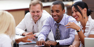 Happy business people sitting around the table at the meeting